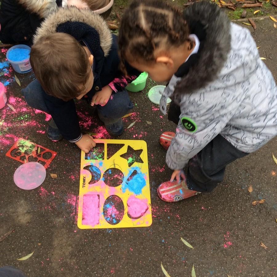 Creating Rangoli patterns with powder paint.