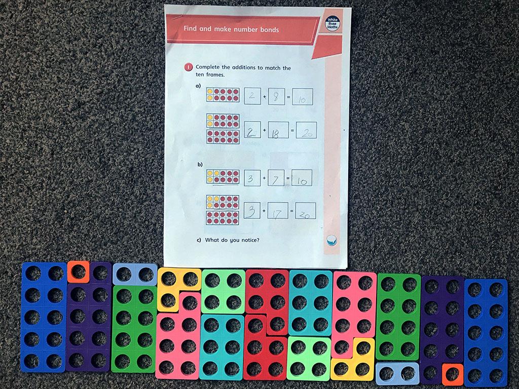 Alexis is busy at home using her numicon to help her learn number bonds.jpeg
